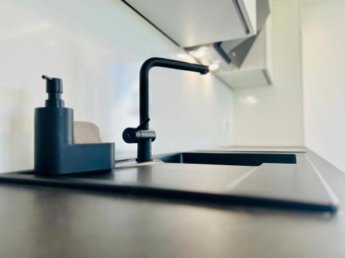 a kitchen counter with a sink and a faucet at City Apartments in Herzogenaurach