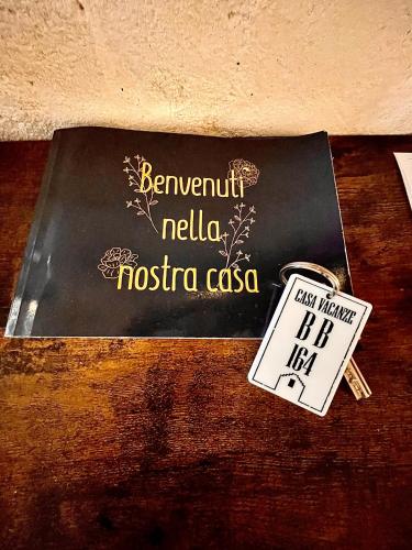 a book on a table with a tag on it at CASA VACANZE BB 164-166 in Matera