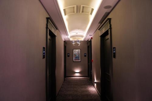 a corridor of a hallway with a long hallway at ARCHSTONE BY KETENCİ HOTEL in Konak