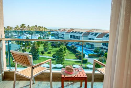 a room with a balcony with a table and chairs at Tui Magic Life Jacaranda in Side