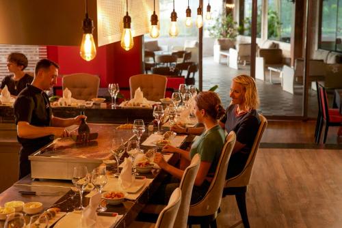 a group of people sitting at a table in a restaurant at Tui Magic Life Jacaranda in Side