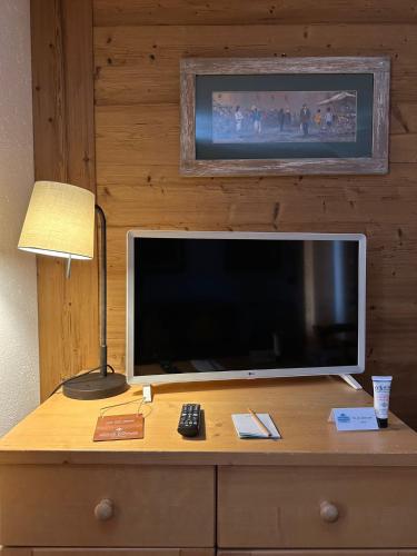 a flat screen tv sitting on top of a dresser at Hotel Du Grand Paradis - 1899 Auberge Boutique in Cogne