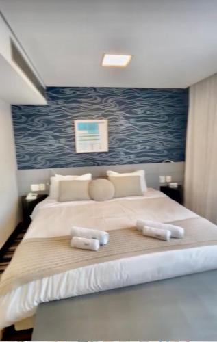 a bedroom with a large bed with two pillows at Oscar Freire Hotel RDS Jardins in São Paulo