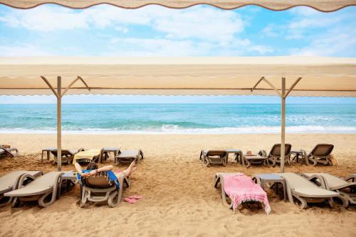 a group of chairs and tables on the beach at Tui Magic Life Jacaranda in Side