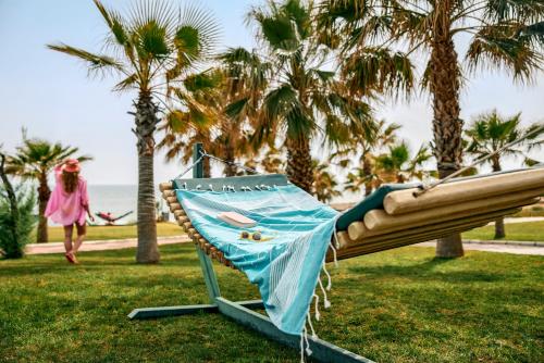 a girl is laying on a swing in a park at Tui Magic Life Jacaranda in Side