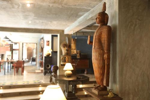 a statue of a man on a wall in a room at Aayu Hanthana Boutique Hotel in Kandy