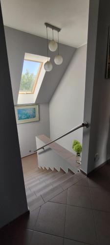 a room with a staircase with two lights and a window at Mrowisko in Masłowice