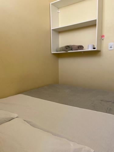 a room with a bed and a cupboard at Stylo Hotel in Juiz de Fora