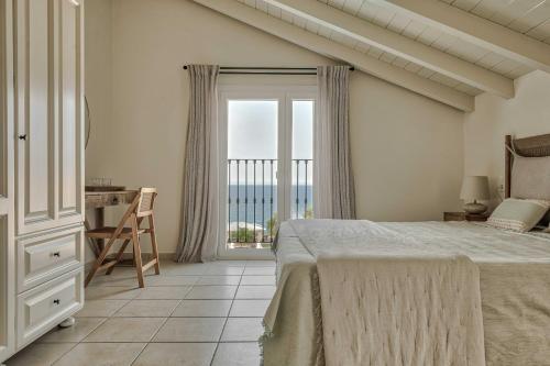 1 dormitorio con cama y vistas al océano en Erietta Aparthotel, en Tsilivi