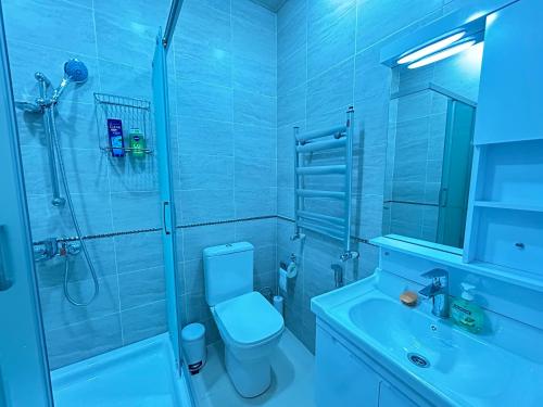 y baño con ducha, aseo y lavamanos. en White Stone Residence 47 en Bakú