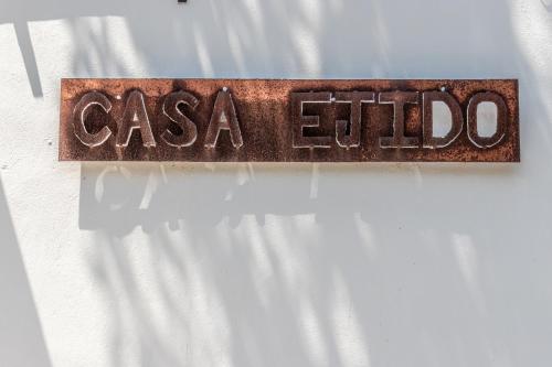 a metal sign with the word casa old on a white curtain at Bed & Breakfast Casaejido in Playa del Carmen