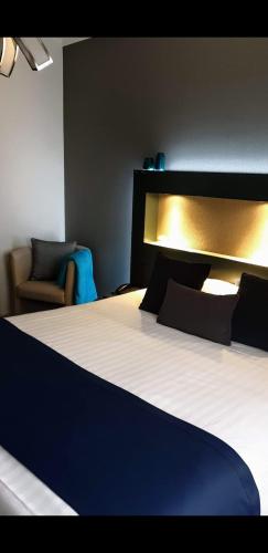 Postel nebo postele na pokoji v ubytování Belrom Hotel