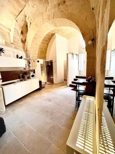 a kitchen and dining room with a stone wall at CASA VACANZE BB 164-166 in Matera