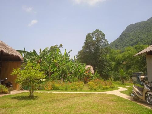a motorcycle parked on a path in a garden at Ngoặng homestay - phòng nghỉ trọ in Chiêm Hóa