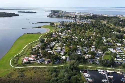 an aerial view of a small island in the water at Modern holiday Chalet on lake side holiday park in Lauwersoog