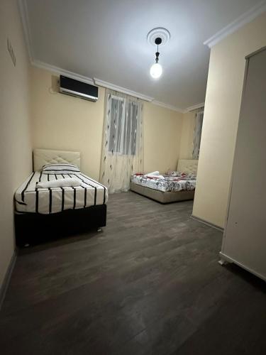 an empty room with two beds in it at Guest House Violeta in Gonio