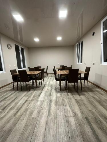 a dining room with wooden tables and chairs at Guest House Violeta in Gonio