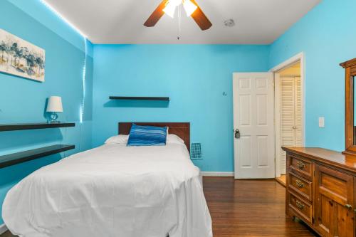 a blue bedroom with a bed and a ceiling fan at The Blue Room near Yale Hospital/Bridgeport in Bridgeport