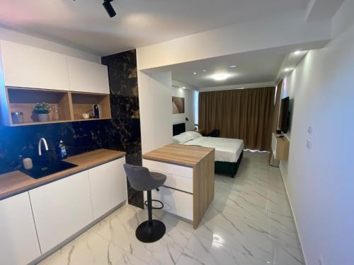 a hotel room with a bed and a kitchen with a sink at Guest House Ana Residence in Zadar
