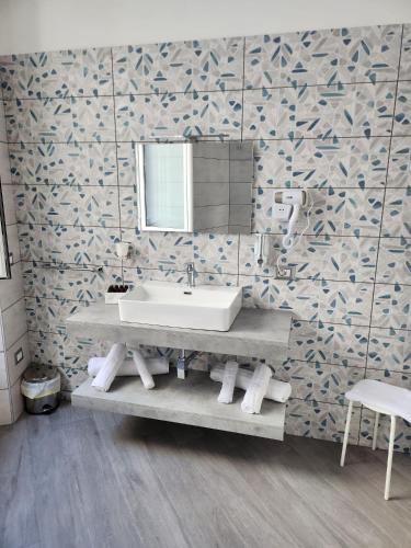 a bathroom with a sink and a mirror at Gradini Partenopei in Naples