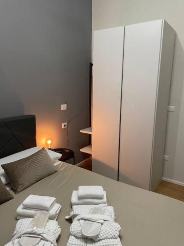 a bedroom with a bed with towels on it at Cucchiari Suite 1A in Modena