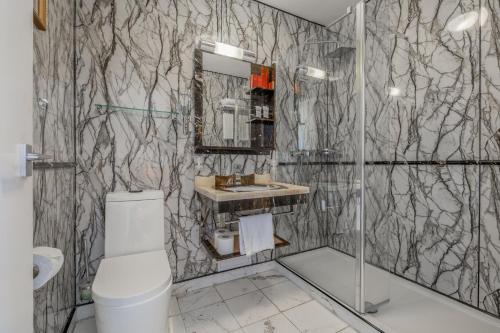 a bathroom with a shower and a toilet and a sink at Muthu Fort William Hotel in Fort William