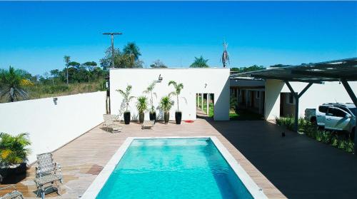 a swimming pool in front of a house at Verdant hotel in Bonito