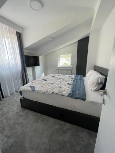 a bedroom with a large bed in a room at King Size Apartment in Skopje