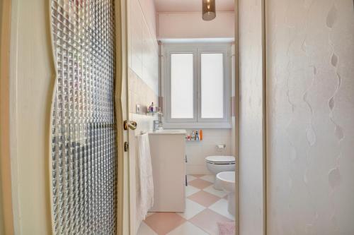 a bathroom with a toilet and a sink and a shower at Ca' Muna - Sea View Penthouse, Private Rooftop, Walking to the Beach in Rapallo