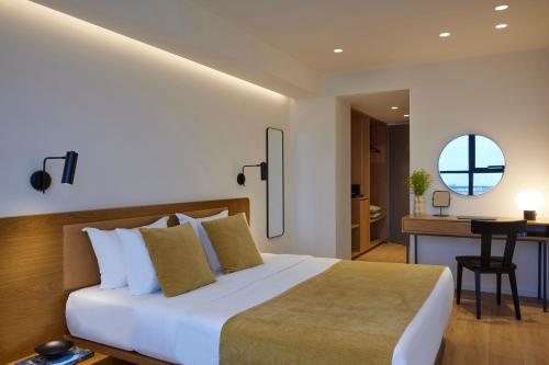a bedroom with a bed and a desk in a room at Noa Hotel in Thessaloniki