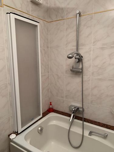 a bathroom with a shower and a bath tub at Il Nido del Gabbiano in Savona