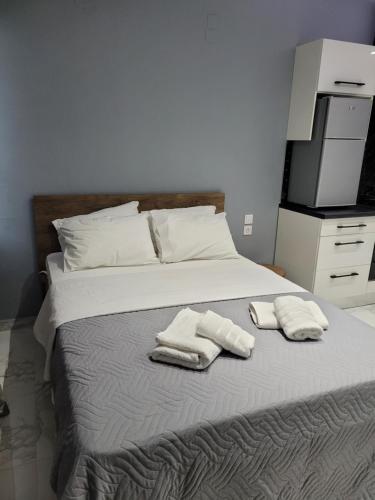 a bedroom with a bed with two towels on it at Studio LUX in Ioannina