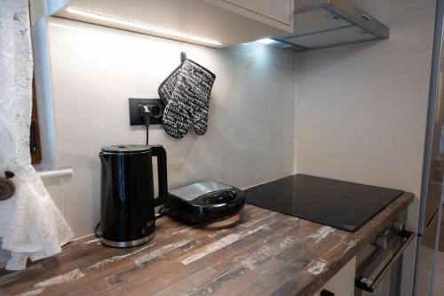 a coffee maker on a counter in a room at Perion stone apartment sea front in Kolymvari