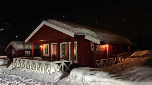 a small house in the snow at night at Saltvold Hytte Nr8 in Røldal
