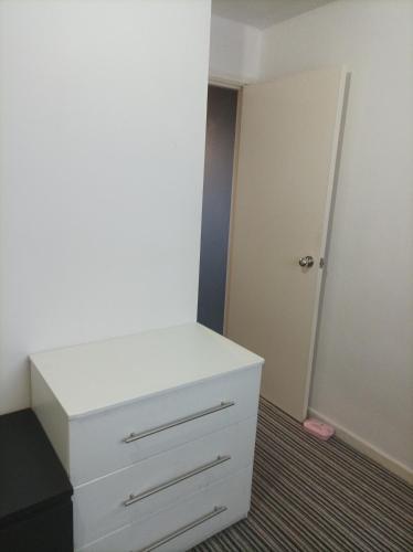 a white dresser in a room with a door at GEMLİK ON THE BEACH in Gemlik