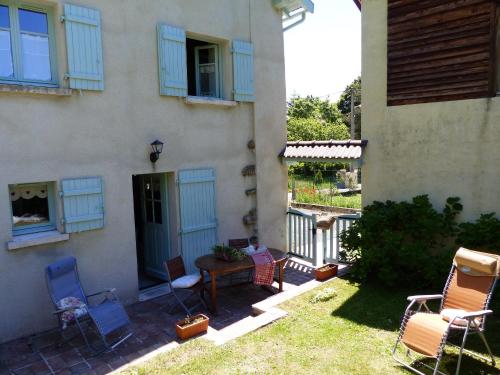 a patio with chairs and a table in front of a house at Gite d'Appy in Les Cabannes