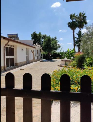a fence in front of a house with a driveway at Villa Antonella in Augusta