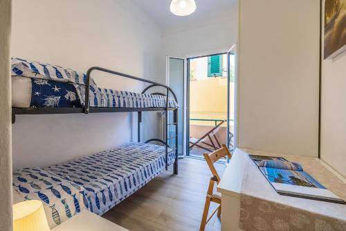 a room with two bunk beds and a desk at Casa Castelletto in Finale Ligure