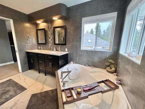 a large bathroom with a tub and a sink at Vintner's Nook B&B in Kelowna