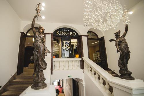 a staircase in a store with statues on the stairs at Apartmanski smestaj King Bo in Niš