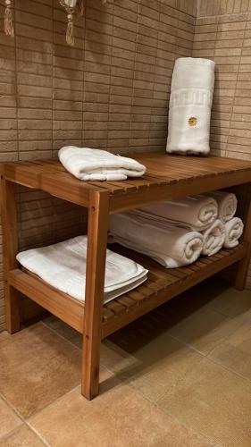 a wooden shelf with towels on it in a bathroom at Finca Los Molinos in La Alameda de Cervera