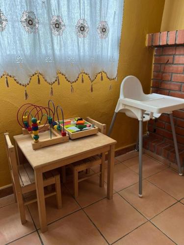 a wooden table with a childs toys on it at Finca Los Molinos in La Alameda de Cervera