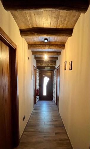 a long hallway with a wooden ceiling and a hallway with a hallwayngthngthngth at Casa A Poza in Samos