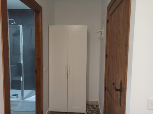 a white cabinet in a bathroom with a shower at Conde Lucanor in Belmonte