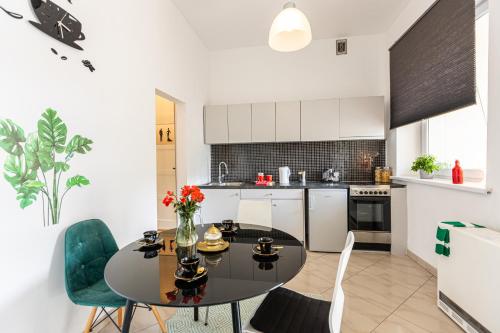 a kitchen with a table and chairs in a room at Vintage Senacka 9/7 Apartment in Krakow