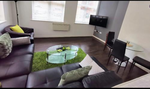 a living room with a couch and a glass table at J Quarter - sleeps 5 long term & families comfortably, 4 beds, 2 bathrooms in Birmingham