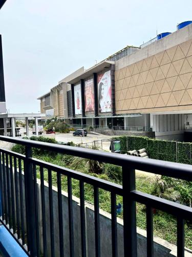 a view from a balcony of a building with billboards at Amani Grand Citygate 308 in Davao City