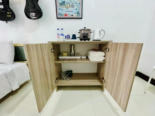 a cupboard in a room with a sink and towels at London Unit Tagaytay Wifi/Netflix/Parking in Tagaytay