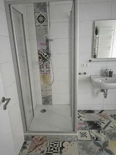 a shower with a glass door in a bathroom at WALDWERK am Wasserfall in Triberg