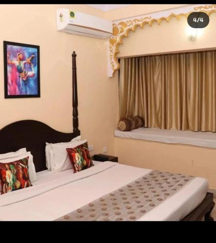 a hotel room with two beds and a window at HOTEL kalika palace in Udaipur